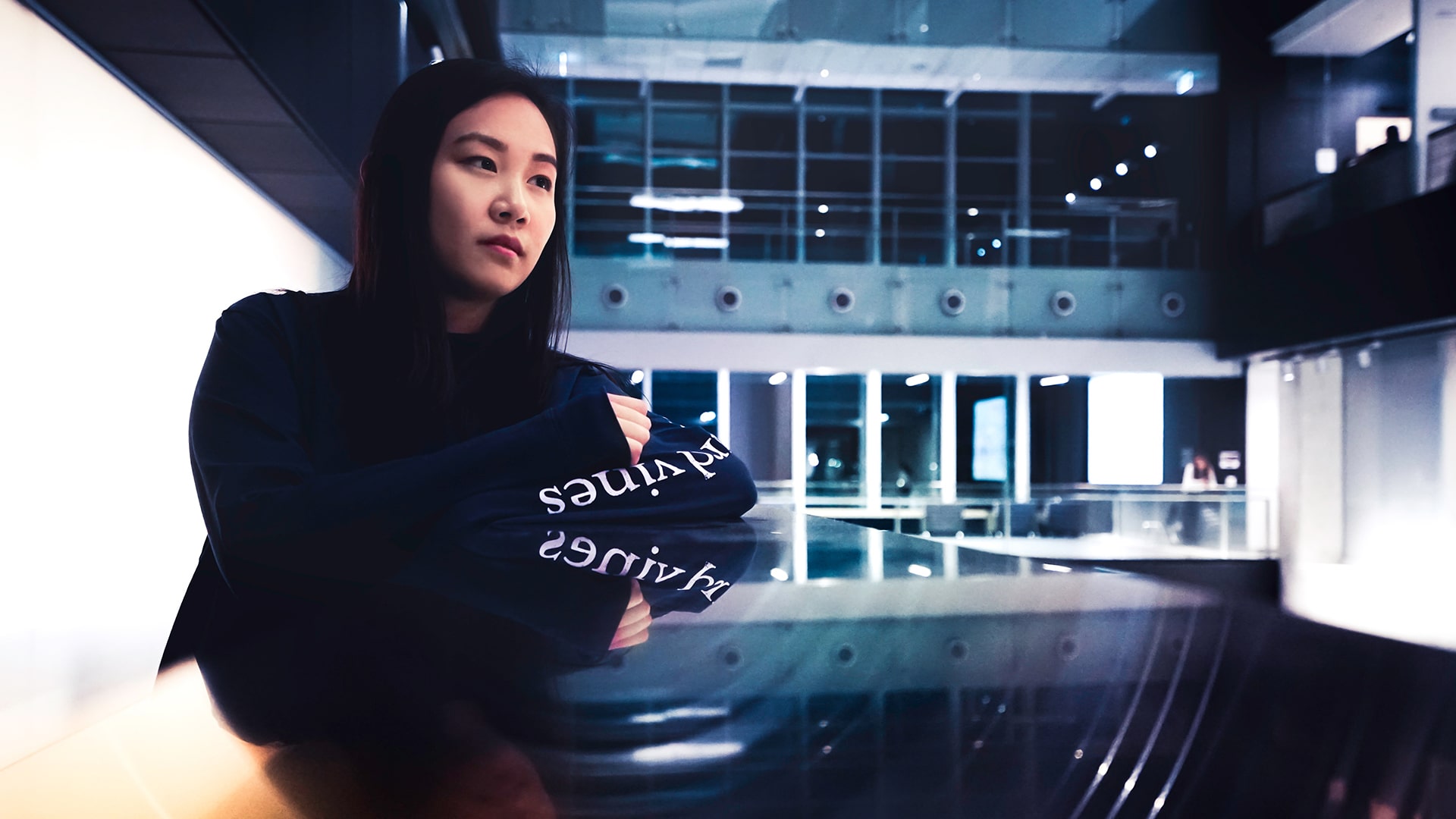 Black hoodie girl posing on desk